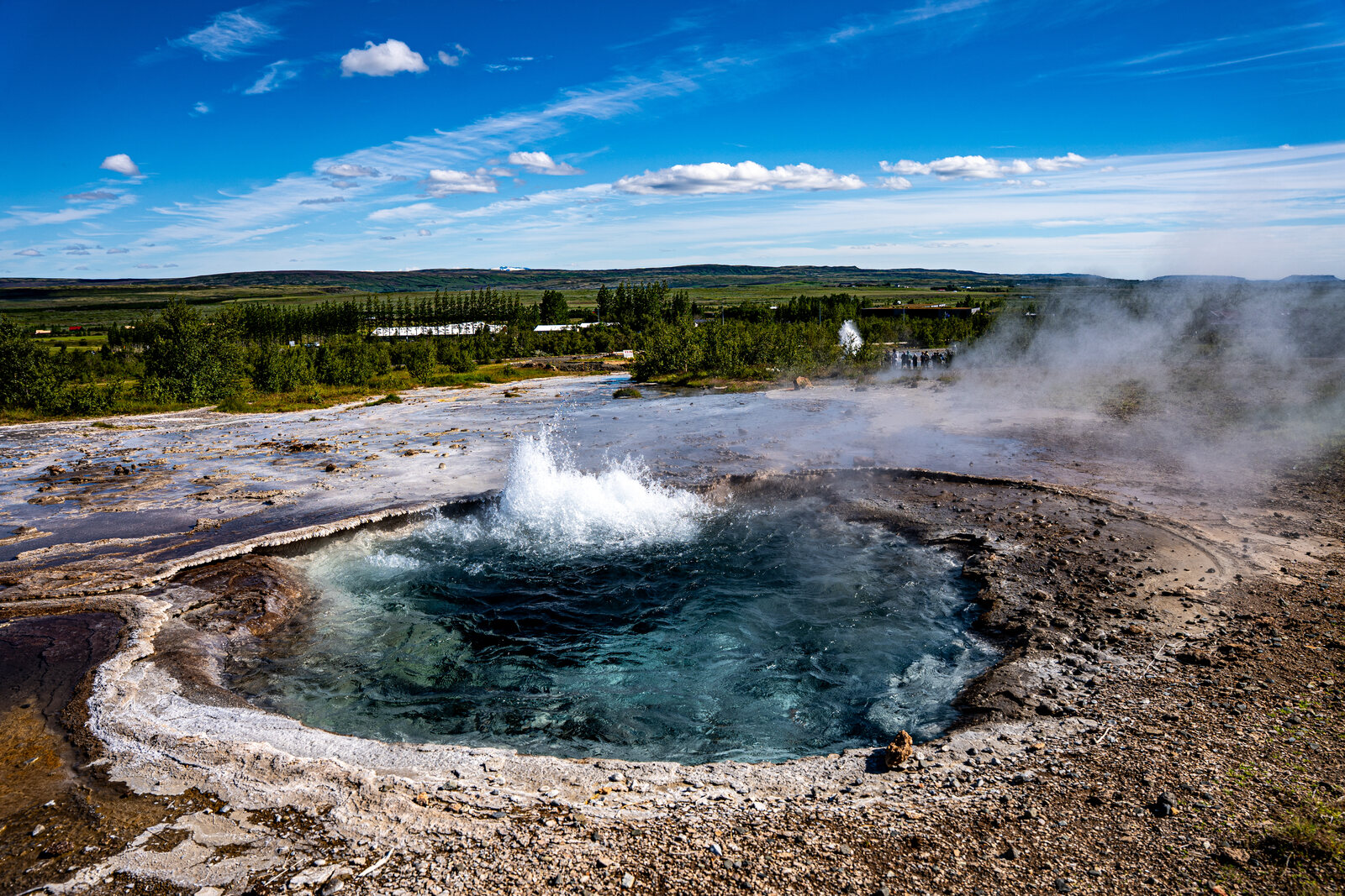Strokkur's turquoise pool bulging moments before an eruption at the Geysir geothermal area
